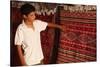 Boy showing a rug in a carpet shop, Toujane, Tunisia-Godong-Stretched Canvas