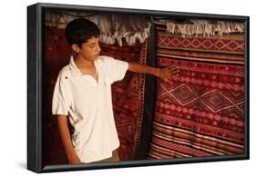Boy showing a rug in a carpet shop, Toujane, Tunisia-Godong-Framed Photographic Print