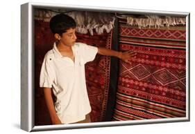 Boy showing a rug in a carpet shop, Toujane, Tunisia-Godong-Framed Photographic Print