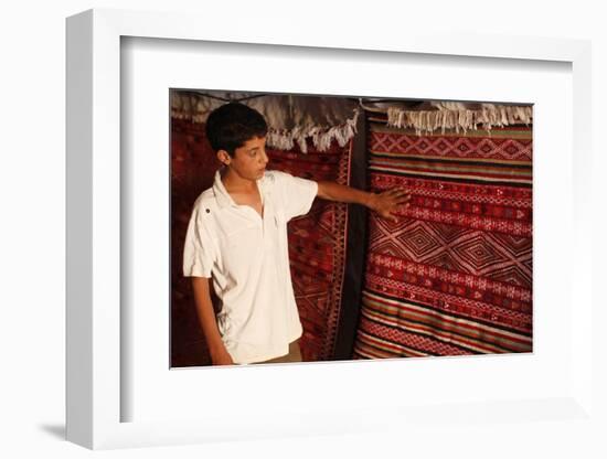 Boy showing a rug in a carpet shop, Toujane, Tunisia-Godong-Framed Photographic Print
