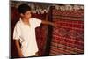 Boy showing a rug in a carpet shop, Toujane, Tunisia-Godong-Mounted Photographic Print