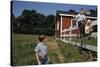 Boy Sitting on Fence Waving to Friend-William P. Gottlieb-Stretched Canvas