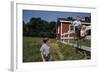 Boy Sitting on Fence Waving to Friend-William P. Gottlieb-Framed Photographic Print