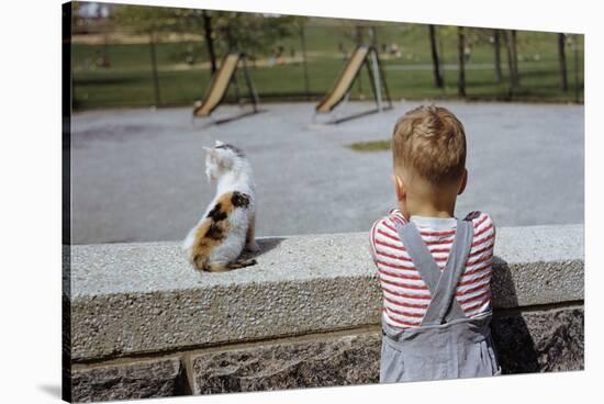 Boy Standing with Kitten in Schoolyard-William P. Gottlieb-Stretched Canvas