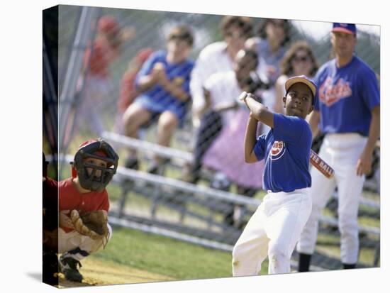 Boy Swinging a Baseball Bat on a Field-null-Stretched Canvas