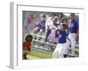 Boy Swinging a Baseball Bat on a Field-null-Framed Premium Photographic Print