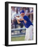 Boy Swinging a Baseball Bat on a Field-null-Framed Photographic Print