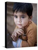 Boy Waits to Receive a Ration of Donated Rice at Food Distribution Center in Islamabad, Pakistan-null-Stretched Canvas