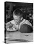 Boy Wearing Baseball Uniform Eating Banana Split at Soda Fountain Counter-Joe Scherschel-Stretched Canvas