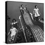 Boys and Girls Play on the Slides at a Playground-null-Stretched Canvas