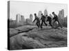 Boys Climbing About on Rock Formation in Central Park as Essex House Looms Amidst Skyline of City-Bill Ray-Stretched Canvas