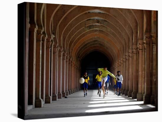 Boys Play Soccer Through an Arched Hallway at the Allahabad University Campus-null-Stretched Canvas