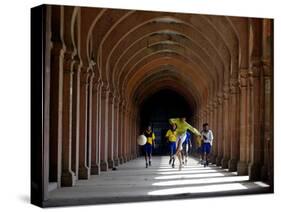 Boys Play Soccer Through an Arched Hallway at the Allahabad University Campus-null-Stretched Canvas