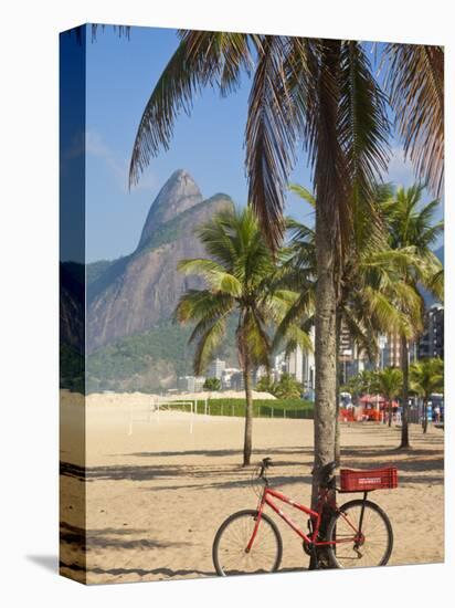 Brazil, Rio De Janeiro, Leblon Beach, Bike Leaning on Palm Tree-Jane Sweeney-Stretched Canvas