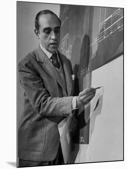 Brazilian Architect Oscar Niemeyer Discussing Design for the United Nations Headquarters Buildings-null-Mounted Premium Photographic Print