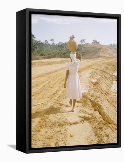 Brazilian Woman Walking Down a Sandy Road Carrying a Large Jar on Her Head-Dmitri Kessel-Framed Stretched Canvas