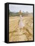 Brazilian Woman Walking Down a Sandy Road Carrying a Large Jar on Her Head-Dmitri Kessel-Framed Stretched Canvas