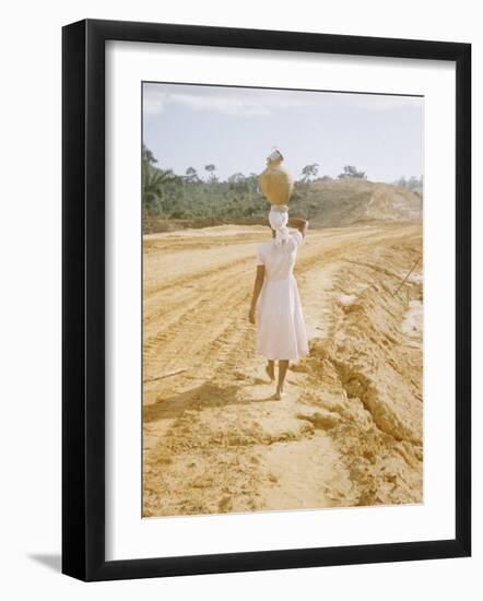 Brazilian Woman Walking Down a Sandy Road Carrying a Large Jar on Her Head-Dmitri Kessel-Framed Photographic Print