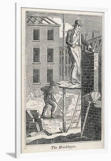 Bricklayer Standing on a Rather Precarious Looking Scaffold, His Assistant Mixes Mortar Behind Him-null-Framed Photographic Print