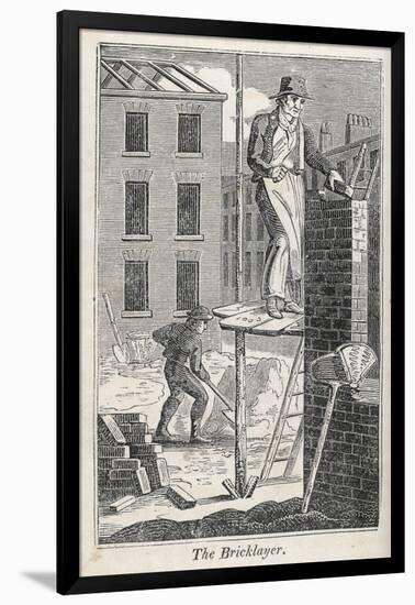 Bricklayer Standing on a Rather Precarious Looking Scaffold, His Assistant Mixes Mortar Behind Him-null-Framed Photographic Print