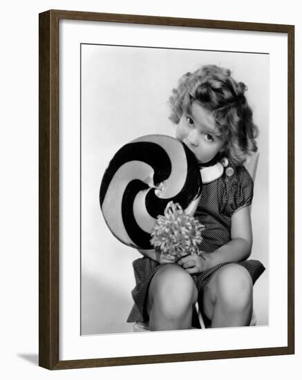 Bright Eyes, Shirley Temple Eating a Big Lollipop, 1934-null-Framed Photo