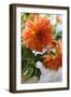 Bright orange flowers on display on kitchen table-Stacy Bass-Framed Photo