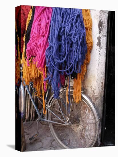 Brightly Dyed Wool Hanging Over Bicycle, Marrakech, Morrocco, North Africa, Africa-John Miller-Stretched Canvas