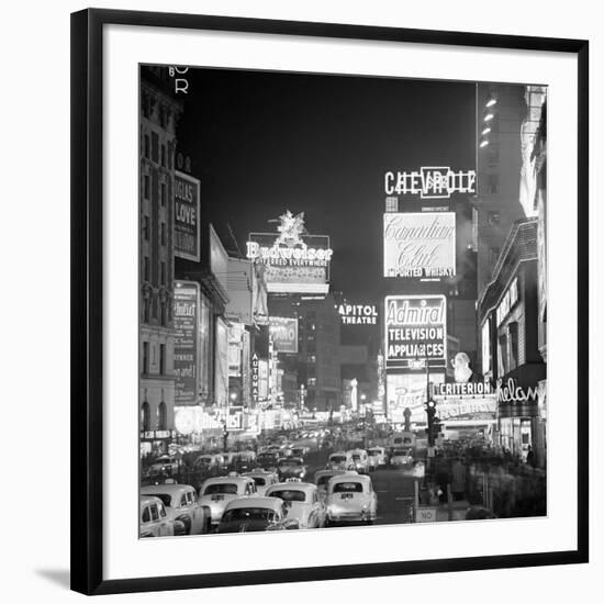 Brightly Lit Signs Shining over Traffic Going Down Broadway Towards Times Square-Andreas Feininger-Framed Photographic Print