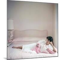 British actress Joan Collins in a pink bedroom with a pink toy poodle (photo)-null-Mounted Photo