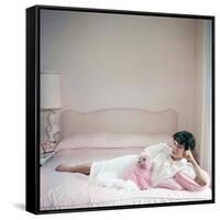 British actress Joan Collins in a pink bedroom with a pink toy poodle (photo)-null-Framed Stretched Canvas