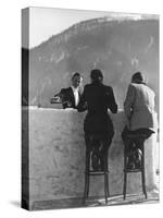 British Couple on High Stools at Ice Bar Outdoors at Grand Hotel as Waiter Pours Them Drinks-Alfred Eisenstaedt-Stretched Canvas