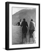 British Couple on High Stools at Ice Bar Outdoors at Grand Hotel as Waiter Pours Them Drinks-Alfred Eisenstaedt-Framed Photographic Print