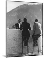 British Couple on High Stools at Ice Bar Outdoors at Grand Hotel as Waiter Pours Them Drinks-Alfred Eisenstaedt-Mounted Photographic Print