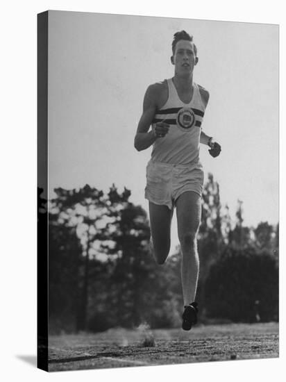 British Track Runner Roger Bannister Running, the First Person to Run a Mile in under Four Minutes-Cornell Capa-Stretched Canvas