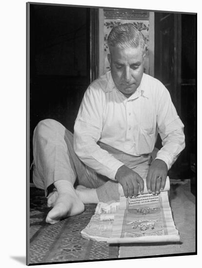 Broker Astrologer Reading Horoscope While Trading at Bombay Stock Exchange-Margaret Bourke-White-Mounted Photographic Print