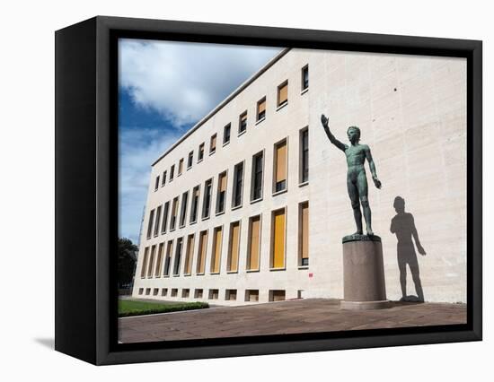 Bronze statue Genio dello Sport outside the Palazzo degli Uffici, Faschist architecture-Jean Brooks-Framed Stretched Canvas