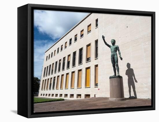 Bronze statue Genio dello Sport outside the Palazzo degli Uffici, Faschist architecture-Jean Brooks-Framed Stretched Canvas