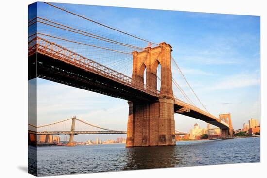 Brooklyn Bridge over East River Viewed from New York City Lower Manhattan Waterfront at Sunset.-Songquan Deng-Stretched Canvas