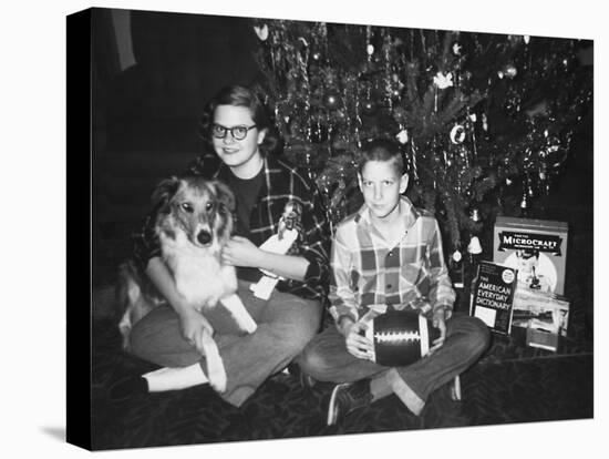 Brother and Sister Pose by the Christmas Tree, Ca. 1960-null-Stretched Canvas