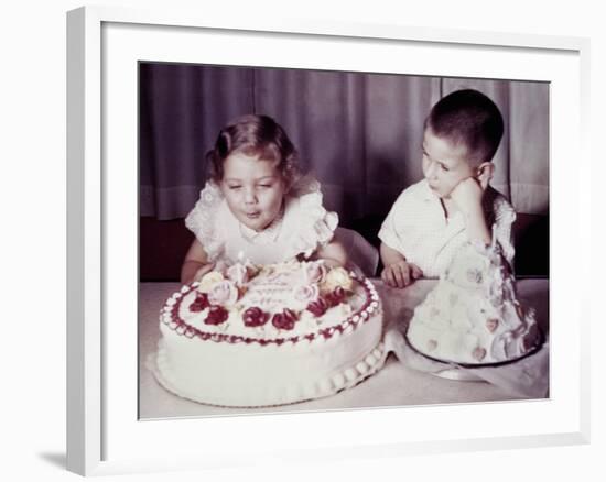 Brother Watches His Sister Blow Out Candles on Birthday Cake, Ca. 1956-null-Framed Photographic Print