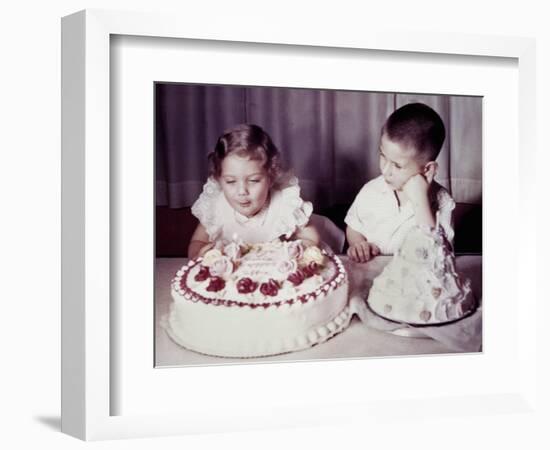 Brother Watches His Sister Blow Out Candles on Birthday Cake, Ca. 1956-null-Framed Photographic Print