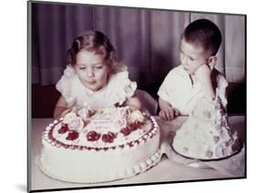 Brother Watches His Sister Blow Out Candles on Birthday Cake, Ca. 1956-null-Mounted Photographic Print