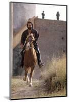 Bud Spencer Riding a Horse on the Set of Soldier of Fortune-null-Mounted Photographic Print