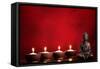 Buddha and Candles on Red Background, Religious Concept.-Sofiaworld-Framed Stretched Canvas