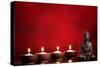 Buddha and Candles on Red Background, Religious Concept.-Sofiaworld-Stretched Canvas