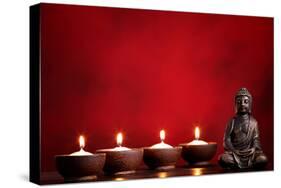 Buddha and Candles on Red Background, Religious Concept.-Sofiaworld-Stretched Canvas