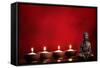 Buddha and Candles on Red Background, Religious Concept.-Sofiaworld-Framed Stretched Canvas