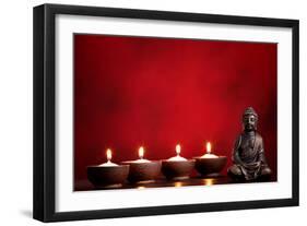 Buddha and Candles on Red Background, Religious Concept.-Sofiaworld-Framed Photographic Print