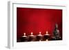 Buddha and Candles on Red Background, Religious Concept.-Sofiaworld-Framed Photographic Print