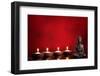 Buddha and Candles on Red Background, Religious Concept.-Sofiaworld-Framed Photographic Print